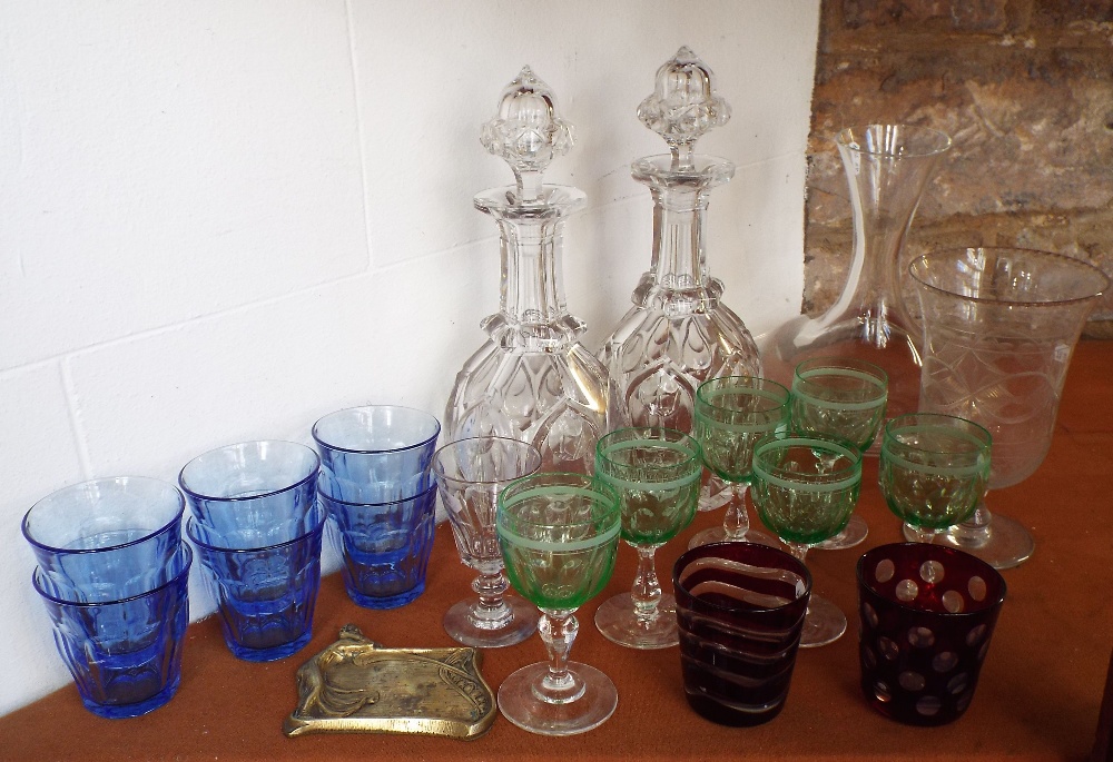 A pair of 19th century glass decanters and stoppers with faceted decoration and acorn shaped