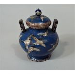 A good quality cloisonné vase and cover, the mid blue ground decorated with a flight of cranes