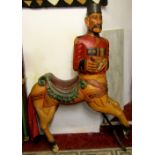 A carved hardwood carousel ride in the form of a centaur, with polychrome decoration, the figurehead