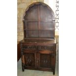 A small reproduction oak cottage dresser, the base enclosed by a pair of rectangular panel doors,