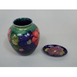 A Moorcroft green ground vase with pink and purple anemone detail with painted signature and