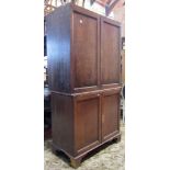 A 19th century oak side cupboard in two associated sections, both enclosed by rectangular moulded