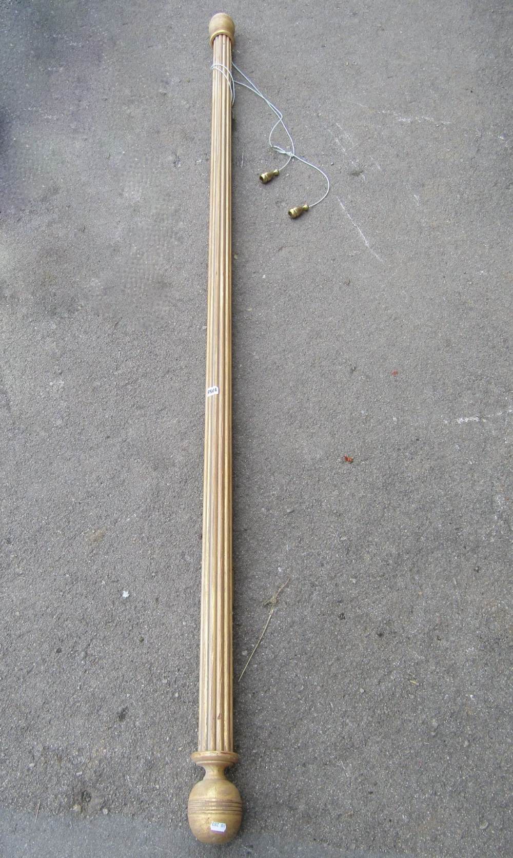 A gilt wood reeded curtain pole with turned finials, 46 cm long (full length)