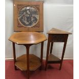 An oak corner table of triangular form on two tiers incorporating carved panels and fruiting