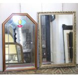 A contemporary gilt framed wall mirror of rectangular form with bevelled edge plate and foliate
