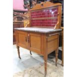 An Edwardian satin walnut marble top wash stand with raised tiled splashback, pierced inverted heart