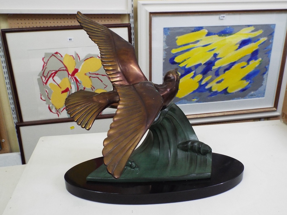 Art Deco gilt and verdigris spelter character group of a flying bird on a wave, upon an oval - Image 2 of 4