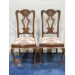 Pair of French carved oak dining chairs, drop in seats and serpentine frames