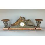 An art deco clock garniture Leda & Swan garniture with an eight day striking movement, raised on a