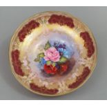 An Aynsley bowl raised on a circular foot, with floral detail to centre signed G Bentley within