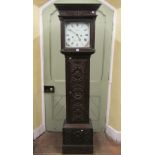 An early 19th century longcase ting tang clock, carved throughout with repeating geometric and other