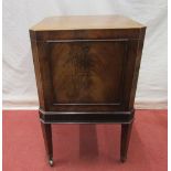 A good Georgian mahogany wine cooler, of square cut form with canted corners, raised on four