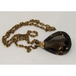9ct fancy chain link necklace hung with a large faceted smoky quartz pendant with yellow metal loop,
