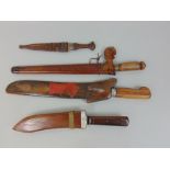 Two Malaysian Kris daggers, with wooden sheaths and handles, together with two further interesting