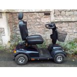 An Invacare Comet mobility scooter, in navy blue painted livery, complete with mains battery charger