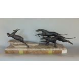 An art deco group, the marble base supporting a spelter group of two greyhounds chasing a stag