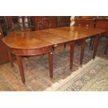 A Georgian style mahogany, three sectional extending dining table, the central drop leaf section