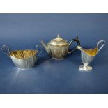 Victorian silver three piece ovoid faceted part fluted tea service, the tea pot with fluted panels