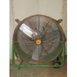An industrial portable electric fan with drum shaped case, tubular frame and painted finish, with