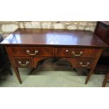 An inlaid Edwardian mahogany kneehole writing desk fitted with four drawers on square taper legs