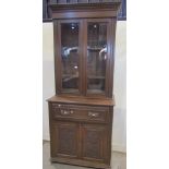 An Edwardian oak secretaire bookcase, the upper recessed section enclosed by a pair of rectangular