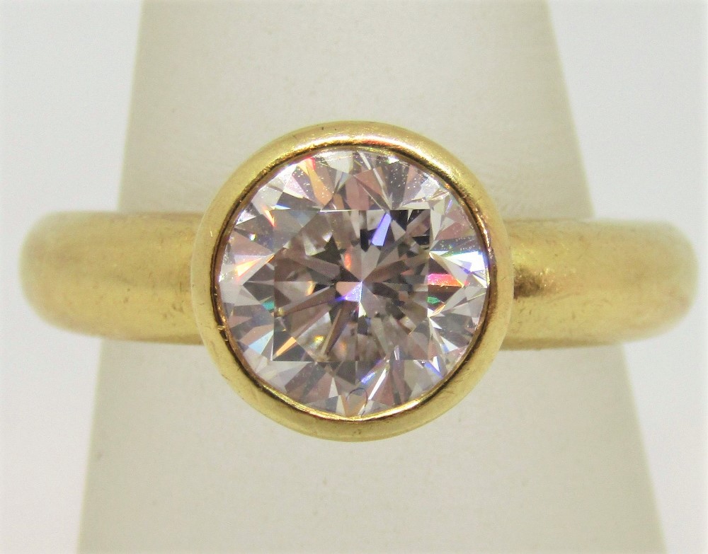 18ct bezel set diamond solitaire ring, the stone 2cts approx, size M/N, 7.7g, with a 1999 HRD