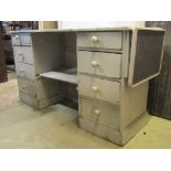 A Victorian pine shop counter with later painted finish, the rectangular top with single drop leaf