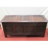 An 18th century or earlier oak coffer, with panelled frame, the front elevation with repeating