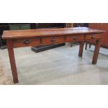 A vintage pine side table, fitted with four frieze drawers, raised on square cut supports, beneath a