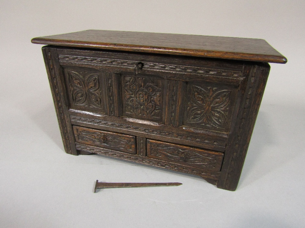 Apprentice mule chest, with rising lid over two frieze drawers, the panelled framework with carved