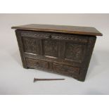 Apprentice mule chest, with rising lid over two frieze drawers, the panelled framework with carved