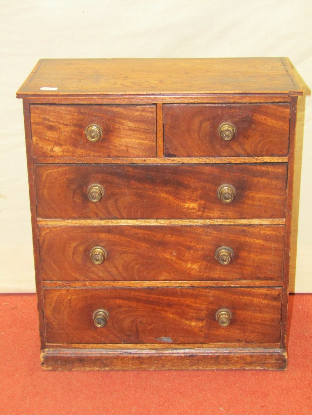 A very small Georgian mahogany table top chest of three long and two short drawers, 42 cm wide, 47