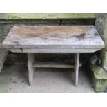 A weathered (silvered) elm garden table, with thick rectangular top, raised on shaped supports,