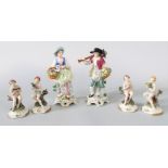 A pair of continental figures of male and female gardeners with flower baskets, 24cm tall approx,