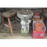 A small weathered cast composition stone bird bath, the circular cabbage/acanthus leaf relief bowl