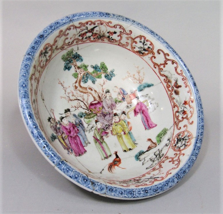 A 19th century oriental bowl with famille rose painted decoration of male characters in a
