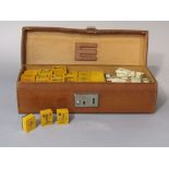 A Mahjong set in a mid brown leather case
