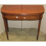 A Regency mahogany demi-lune foldover top tea table, with reeded outline and ebony stringing to