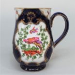 A mid 18th century tankard, probably Worcester, with reserved gilded panels incorporating exotic