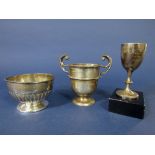 Silver golfing twin handled trophy together with a further golfing pedestal bowl and further cup,