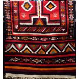 Full pile Kelim runner decorated with various red medallions upon a black ground, 240 x 125 cm