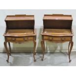 A pair of French bedside tables, with raised shelved backs over serpentine fronts fitted with a