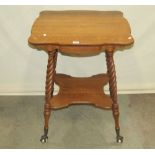 A late 19th century medium to light oak two tier occasional table with shaped and moulded outline,