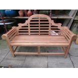 A contemporary Lutyens teak three seat garden bench