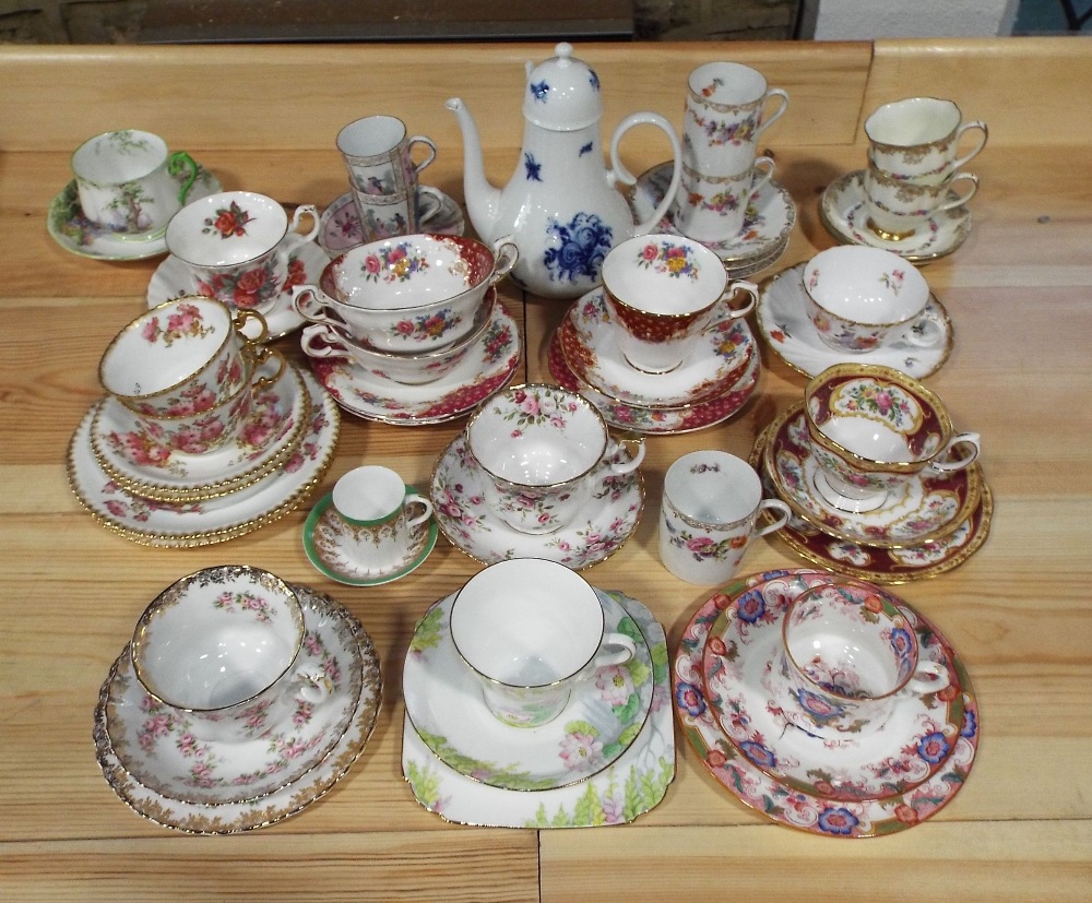 A collection of decorative cups and saucers and trios including Royal Albert Dimity Rose,