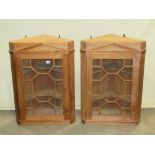 A pair of good quality Georgian style pine hanging corner cabinets each enclosed by an astragal
