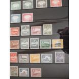 A large collection of Mint GB Commonwealth stamps from KGVI to QEII on Hagner sheets in a black