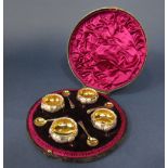 Good cased set of four circular salts, with spoons, the salts with gilt interior and scallop shell