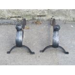 A pair of andirons with pointed cone shaped finials