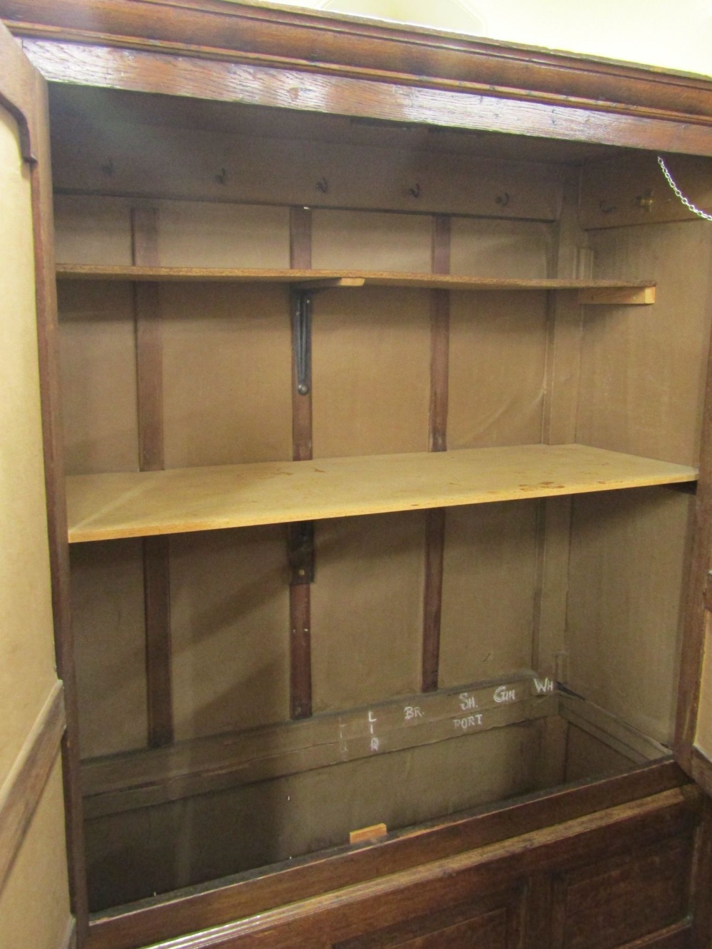 A Georgian oak livery cupboard, the upper section enclosed by a pair of panelled doors with - Image 2 of 2